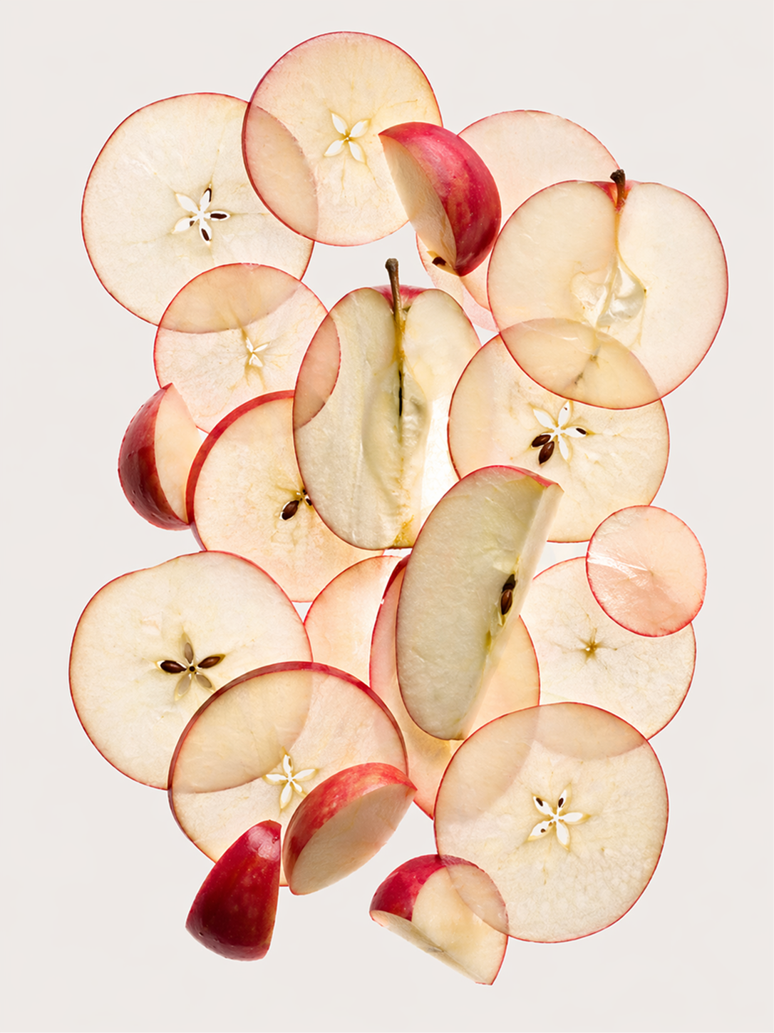 A clean editorial still life collage made entirely from sliced {object}, arranged in a refined vertical composition on a very light warm gray background. Include many thin translucent cross sections, partial slices, wedges, halves, and a few longer cut pieces of {object}, layered elegantly with soft overlaps. The composition should feel airy, minimalist, and magazine editorial, with balanced spacing and natural asymmetry. Fresh texture, subtle moisture, soft translucency, delicate inner details visible in some slices, crisp studio photography, soft diffused lighting, highly realistic, isolated background, no props, no text, no numbers, no logos, no page elements. premium food photography, contemporary editorial layout, clean negative space, 3:4
