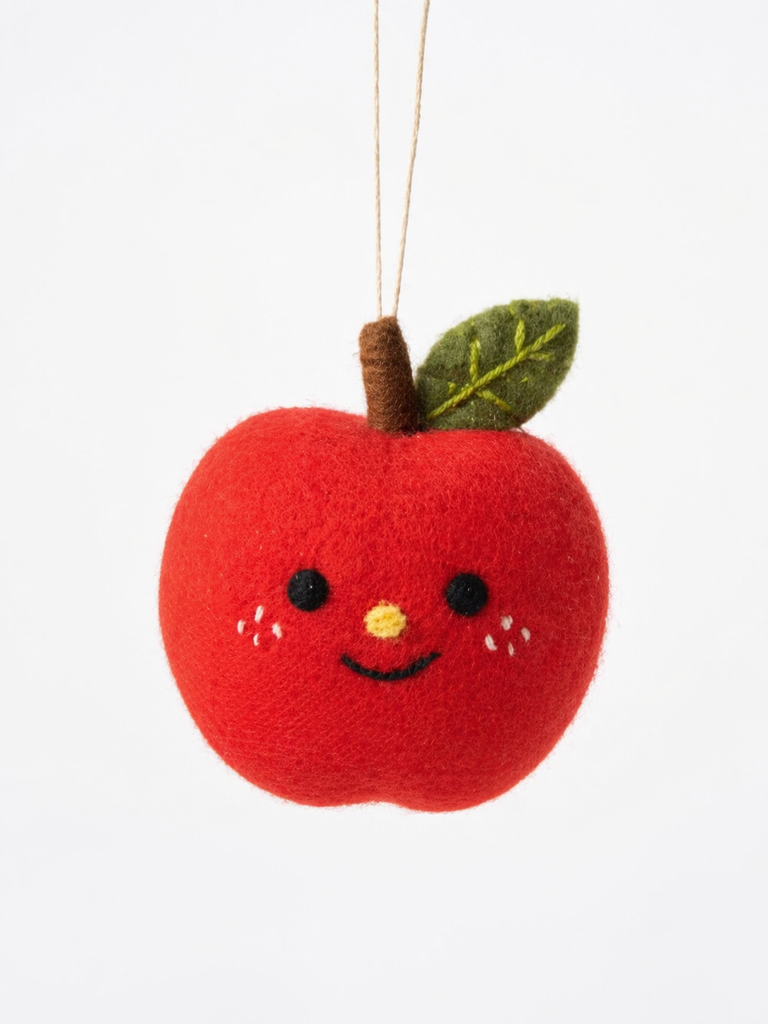 A minimal hanging felt ornament shaped like a cute {object}, photographed against a clean white background. Handcrafted wool-felt texture, soft toy-like charm, tiny string suspension, simple centered studio composition, with a tiny leaf, stitched details, and playful handmade personality. Vertical composition, 3:4 aspect ratio, no text, no letters, no numbers, no watermark, no logo.